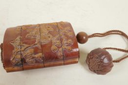 A Japanese four section carved wood inro decorated with birds amongst flowering branches, 3" long