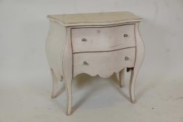 A small cream painted Continental bombe shaped chest of two drawers on cabriole supports, 31"