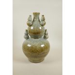 A Chinese mottled celadon glazed pottery double gourd vase with mounted decoration of five smaller