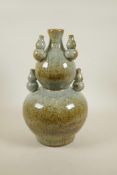 A Chinese mottled celadon glazed pottery double gourd vase with mounted decoration of five smaller