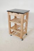 A beechwood kitchen island unit with a black stone top, three slatted tiers and two drawers, 19" x