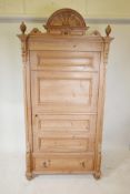 A Continental pine single door armoire, with a single drawer to base, raised on turned supports,