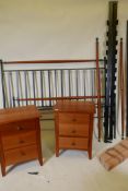 A wrought metal and cherrywood five foot king size bed, matching three drawer bedside chest and