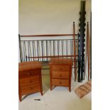 A wrought metal and cherrywood five foot king size bed, matching three drawer bedside chest and