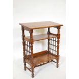 A Liberty & Co. Arts and Crafts three tier book stand with turned lattice work sides, 23" x 13½",