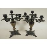 A pair of iron and lacquer leaf pattern four branch, five light candelabra, 10½" high