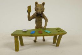 An anthropomorphic cold painted bronze figure of a fox standing at a table dealing black jack cards,