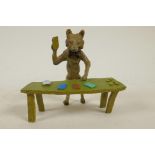 An anthropomorphic cold painted bronze figure of a fox standing at a table dealing black jack cards,