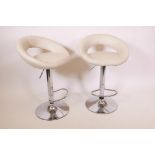 A pair of contemporary adjustable bar stools on steel and cream leather, A/F