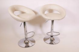 A pair of contemporary adjustable bar stools on steel and cream leather, A/F