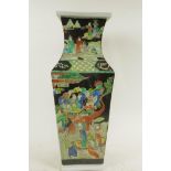 A Chinese square section famille noire porcelain vase decorated with many figures in bright enamels,