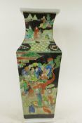 A Chinese square section famille noire porcelain vase decorated with many figures in bright enamels,