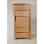 A blond maple wood flight of six drawers, 26" x 19", 48" high