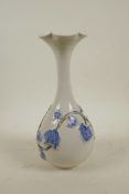 A Chinese blue and white porcelain vase with a slender neck and flared rim, the body with raised