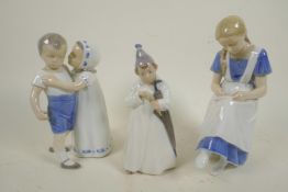 A Royal Copenhagen porcelain figure of a small boy with large umbrella marked NVX 1145, 6¼" high,