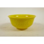 A Chinese yellow ground porcelain bowl with raised dragon decoration, 6 character mark to base, 6"