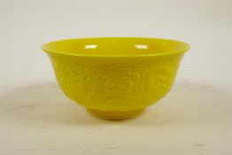 A Chinese yellow ground porcelain bowl with raised dragon decoration, 6 character mark to base, 6"