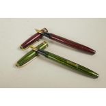 Two Conway Stewart herringbone pattern fountain pens in green and red, both with 14ct gold nibs, 5½"