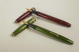 Two Conway Stewart herringbone pattern fountain pens in green and red, both with 14ct gold nibs, 5½"