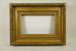 A C19th gilt composition picture frame with raised leaf and flower decoration, 15¾" x 9½" aperture