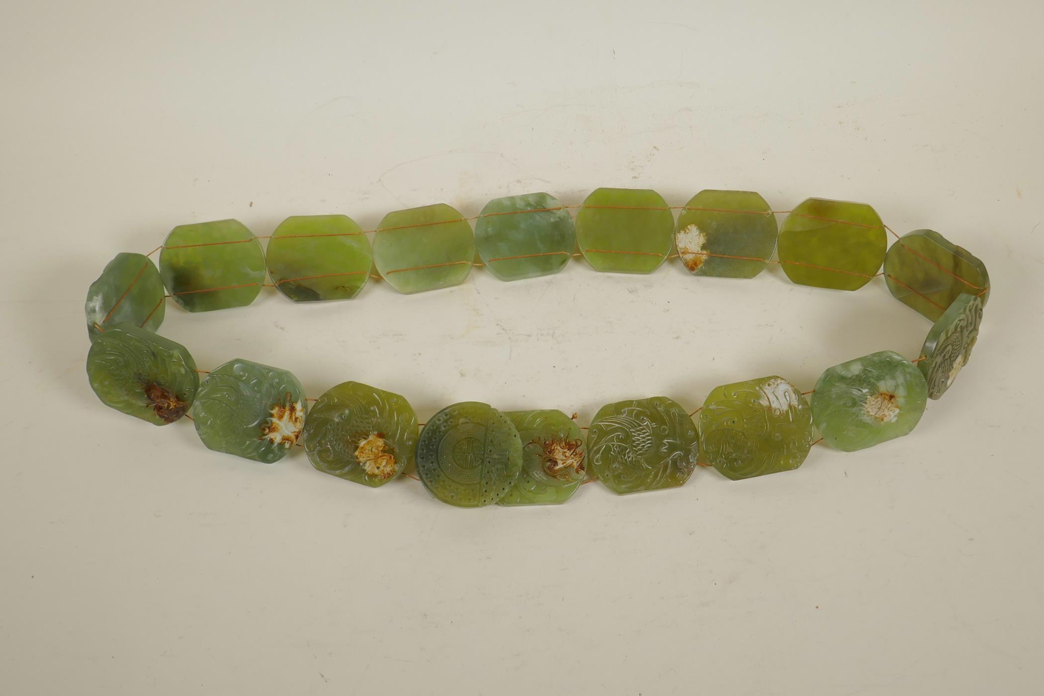 A Chinese green jade belt, with carved decoration to each panel depicting a phoenix, 40" long