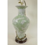A porcelain table lamp base in the form of a Chinese baluster vase with embossed dragon