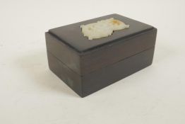 A Chinese hardwood trinket box with an inset jade panel with carved dragon decoration, the box