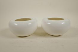 A pair of Chinese cream glazed porcelain vases with rolled rims, inscribed mark to base, 6½"