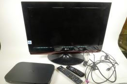 An LG26LG4000 26" television with built in DVD player on swivel pedestal base together with a Sky