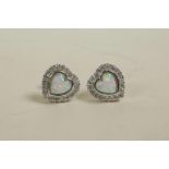A pair of heart shaped silver, cubic zirconium and opalite stud earrings
