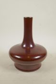 A Chinese copper red glazed vase of squat form with a slender neck, impressed seal mark to base, A/F