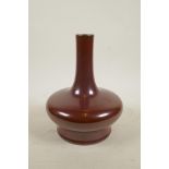 A Chinese copper red glazed vase of squat form with a slender neck, impressed seal mark to base, A/F