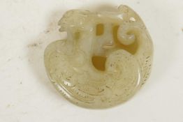 A Chinese jade roundel carved as a dragon, 2"