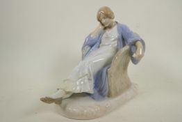 A Royal Copenhagen porcelain figurine of a lady sleeping in a wicker chair, marked with numbers