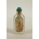 A Chinese reverse decorated glass snuff bottle depicting figures in a landscape, 3" high