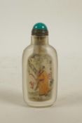 A Chinese reverse decorated glass snuff bottle depicting figures in a landscape, 3" high