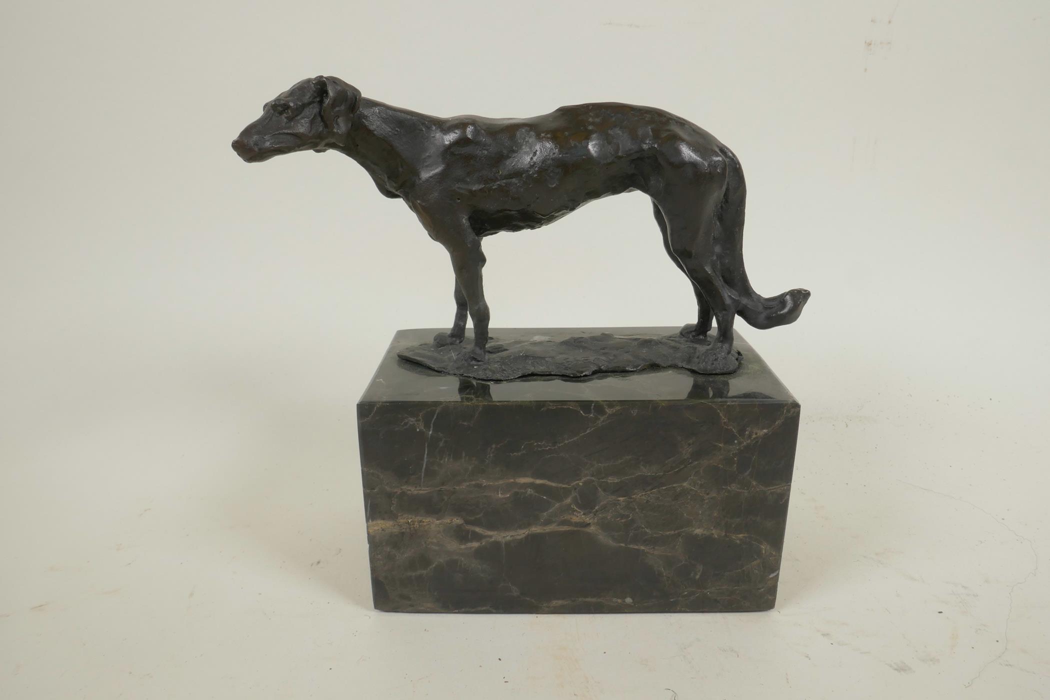 A bronze figure of a Borzoi hound mounted on a marble plinth, 6¼" long