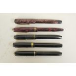 Four Conway Stewart fountain pens and an Esterbrook 'Relief' model 12 fountain pen, all with 14ct