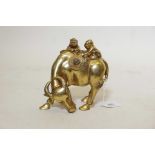 A gilt bronze figure of two boys riding a water buffalo, 6" high