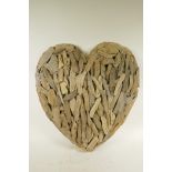An driftwood wall hanging in the form of a heart, 22" wide
