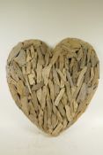 An driftwood wall hanging in the form of a heart, 22" wide