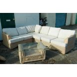 A rattan modular conservatory corner sofa and matching coffee table, larger sections 52" wide