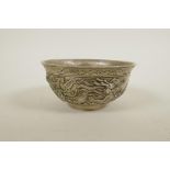A Chinese white metal bowl with raised dragon decoration, 4 character mark to base, 5" diameter