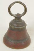 An antique brass bell with engraved and enamelled decoration, 5" high