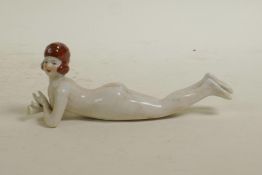 A ceramic Art deco style nude figure of a flapper girl, 5½" long