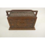 A Chinese three section hardwood box carved with dragons and symbols in a locking frame, 14" x 9½"