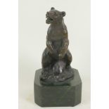 A bronze figure of a standing bear, 5" high, mounted on a heavy plinth