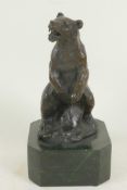 A bronze figure of a standing bear, 5" high, mounted on a heavy plinth