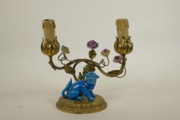 An unusual two branch ormolu lamp with scrolling vine, porcelain flowers and kylin decoration, 8½"