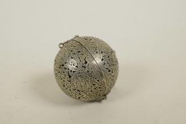 An Islamic white metal ball censer with a gimbal mounted interior, reservoir 2" diameter